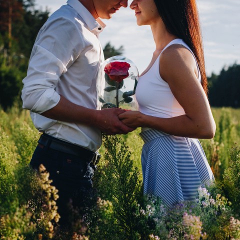 Couple Holding Red Roses Image